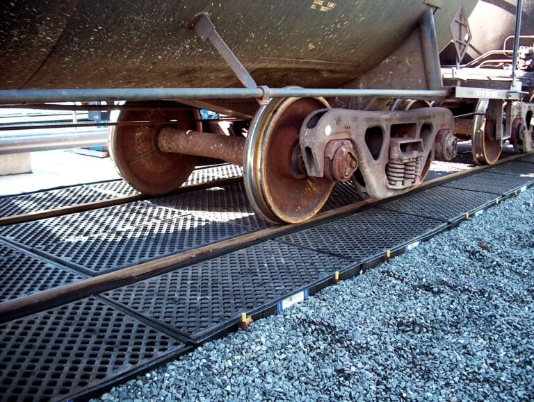 UltraTech spill-containment track pans installed beneath a railcar